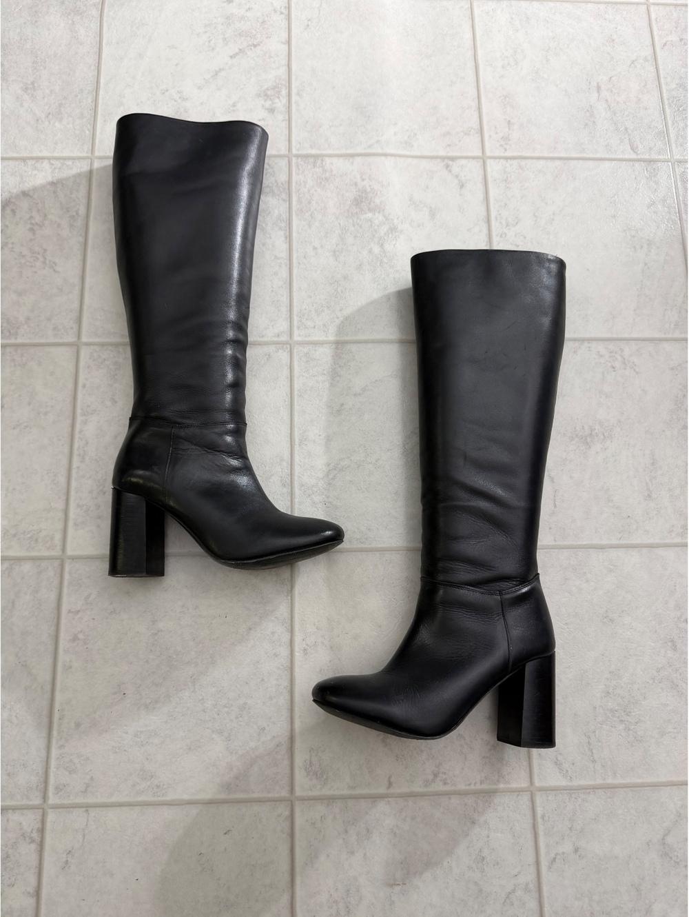 Black knee-high heeled boots